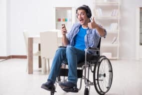 disabled man in a wheelchair listening to french